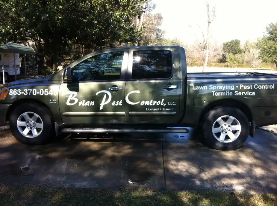 Green Brian Pest Control pickup lettered Lawn Spraying, Pest Control, Termite Service, Licensed and Insured